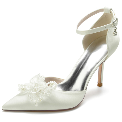 Zapatos de boda de tacón de aguja con punta en punta de marfil y flores con correa en el tobillo